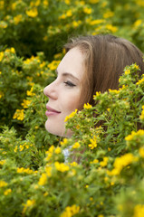 Portrait of girl on a background of yellow flowers.