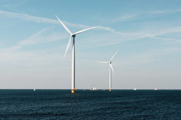 Windmills for the Dutch coast with sailboats
