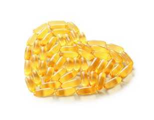 Heart made of fish oil capsules on white background