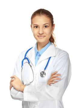 Young female doctor with stethoscope on white background