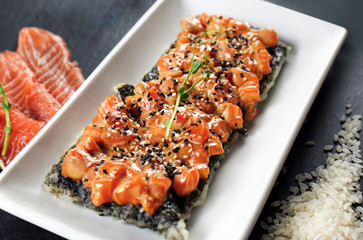 Fillet of salmon with rice and sesame seeds on table