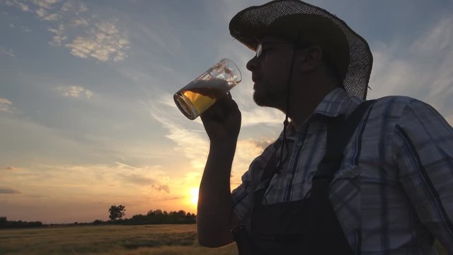 farmer with beer in barley field