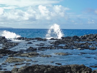 Coastline and rugged lava rocks called Dragon’s Teeth and crashing waves at Makaluapuna Point near Kapalua, Maui, HI, USA