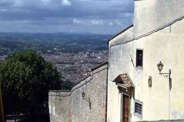 street in Florence in the Oltrarno district, south of Arno, and view of Florence in the distance