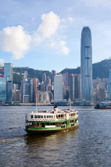 Tuinposter Ferry Crosses Victoria Harbor in Hong Kong © ronniechua