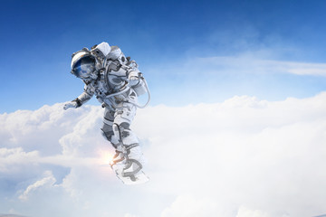 Obraz na płótnie Canvas Spaceman on flying board. Mixed media