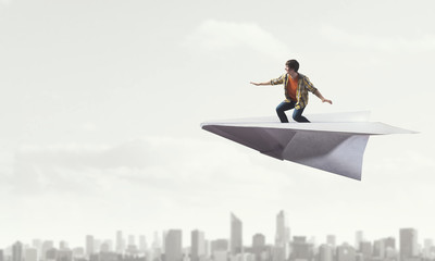 Hipster guy surfing sky . Mixed media