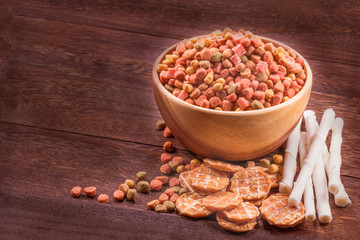 Dog snack ,dog dood, dog chews, dog biscuits on a grey wooden table wall background with copy space .