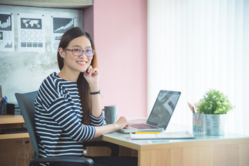 Obraz premium Beautiful asian woman sitting and working with notebook computer in office