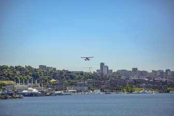 Float plane taking off above the buildings