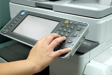 Hand pressing button on photocopy