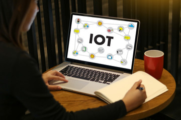 Fototapeta na wymiar IOT business man hand working and internet of things (IoT) word diagram as concept use Browsing Internet computer Searching Data Internet Marketing