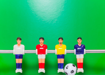 Football table players team on a green background