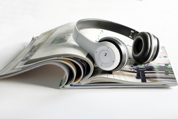 Headphones on magazine.