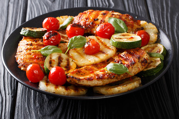 Summer food: Grilled chicken fillet with vegetables in a sweet-hot sauce close-up. horizontal
