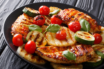 Mexican bbq: Chicken grilled fillet with vegetables in a sweet-hot sauce close-up. horizontal