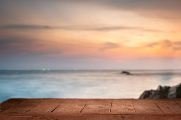 Empty Top of wood table with blurred sea and beach background. For Product display montage. Beach in summer Concept.