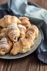  Croissants with chocolate filling on a wooden background