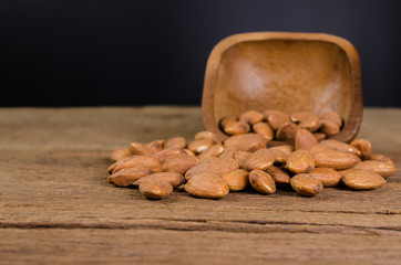 almond from wooden bowl on wooden board