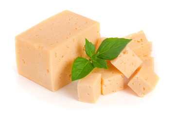 cheese cut into cubes with basil leaves isolated on white background