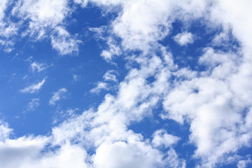 Blue sky background with white clouds and rain clouds on sunny summer or spring day.