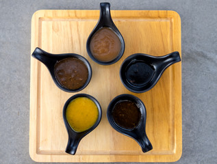 Many sauce in black spoon