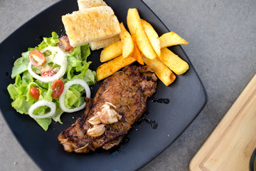 Meat Steak with salad and French Fries and sauce