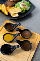 Many sauce in black spoon