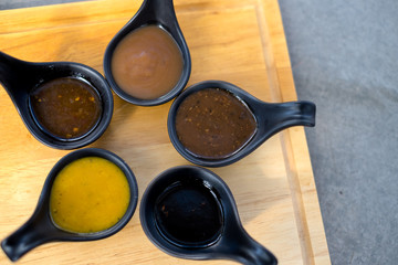 Many sauce in black spoon