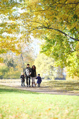 Fototapeta premium Family with children walking in autumn park