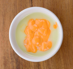 mix tomato sauce mustard and mayonnise in white bowl on wood background