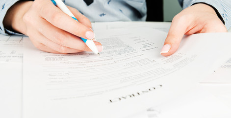 Woman hand signing a contract