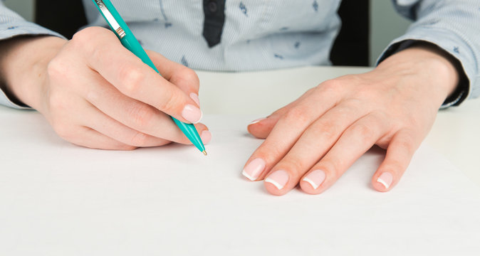 female hand writing on a white background