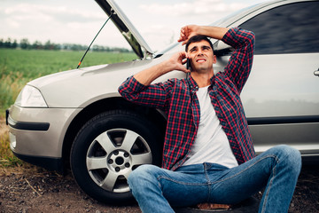 Naklejka premium Man calls to emergency service, broken car