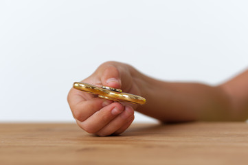 Closeup of child's hand holding fidget spinner