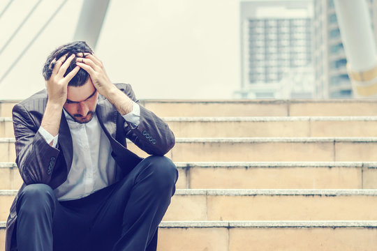 Unemployed businessman stress sitting on stair, concept of business failure and unemployment problem, work life balance, image processing instagram vintage color.