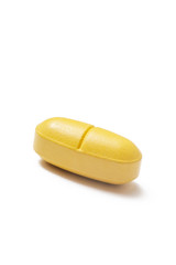 Yellow pill on white