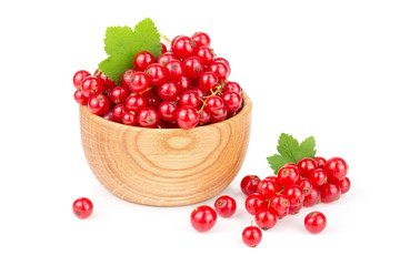 Red currant berries in a wooden bowl with leaf isolated on white background