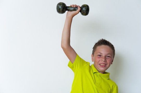 Happy Smiling Tween Boy Lifting Dumbbell