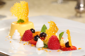 Fine dining - orange panna cotta with raspberries