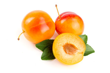 Yellow plum with leaves isolated on white background