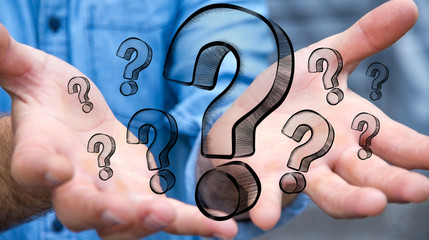 Businessman touching hand drawn question marks