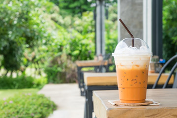 Ice coffee latte on the table in the garden