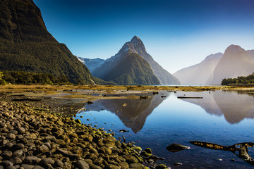 Mitre peak in Milford Sound, south island, New Zealand with the reflection of the mountain in the sea.