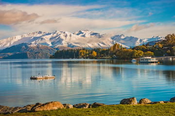 Morning snow at lakeside of Wanaka, south island, New Zealand with a view of snow mountain,...