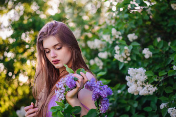 Fototapeta premium The girl with the wreath on his head in lilac