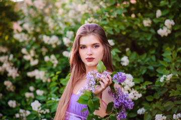 Fototapeta premium The girl with the wreath on his head in lilac