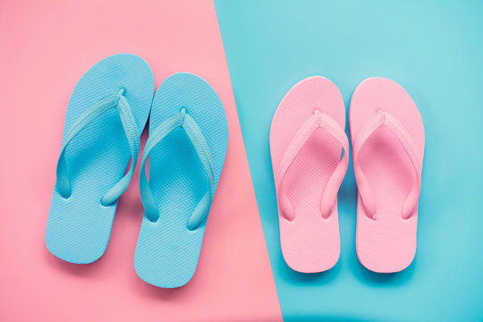 pink and blue sandals on pink and blue pastel background. Lover and Summer concept with copy space.
