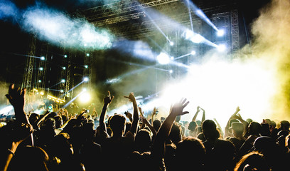 Young people dancing and having fun in summer festival party outdoor - Crowd with hands up...