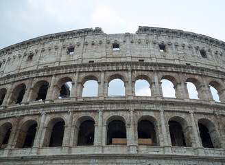 Fototapeta na wymiar Part of the facade of the Colosseum and the sky